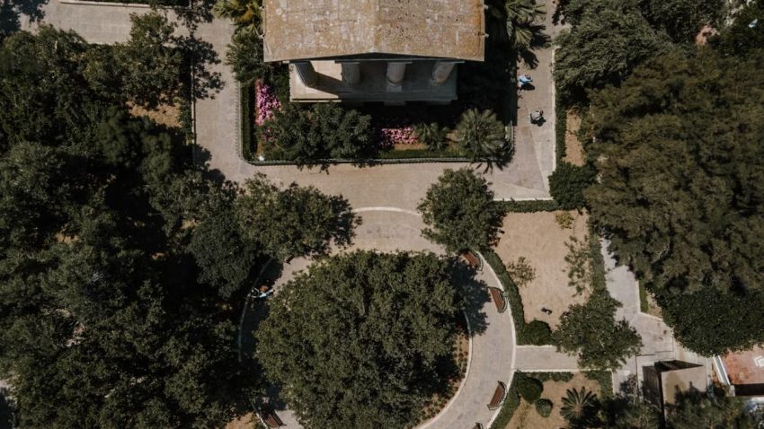 Drone photo showcasing the lush green park and historic architecture in Valletta, Malta.